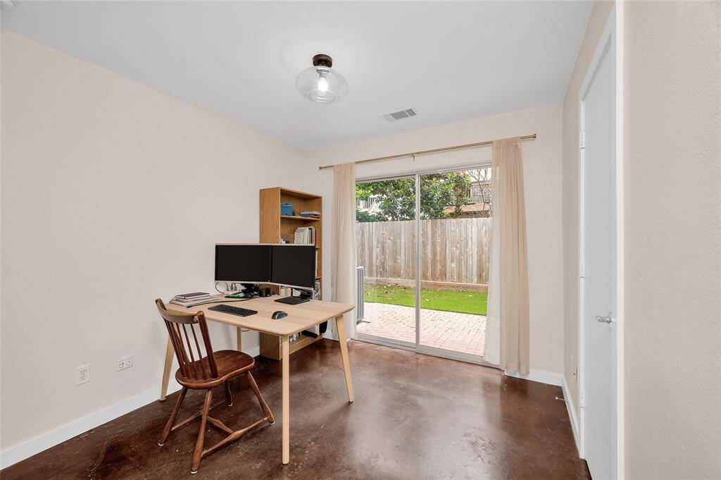 One of the secondary bedrooms, with views of the back yard.