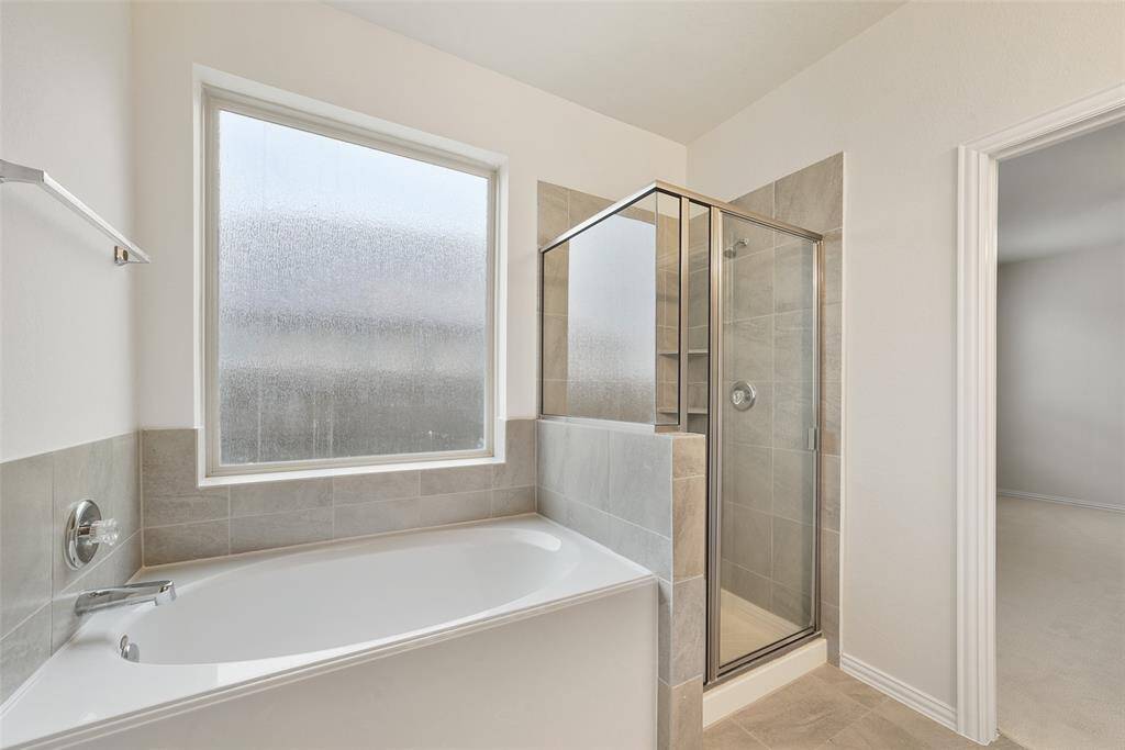 The soaking tub and separate shower offer the potential of a spa-like experience.