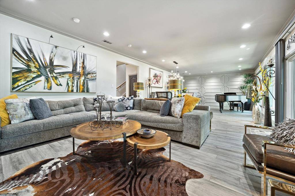 Another view of the living area which opens to the dining room and has a wall of windows across the back of the home