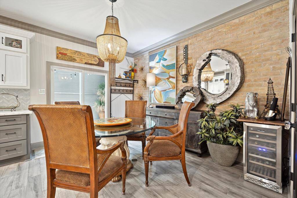 Another view of the breakfast room with brick wall accent which opens to a small courtyard and the utility room.