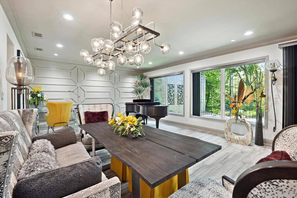 Quality abounds in this stunning remodel which features designer touches throughout and a wall of windows overlooking the lush landscaping.
