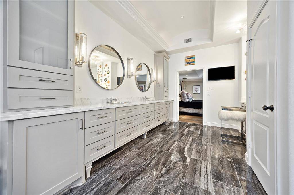 Dual sinks, vanity area and large walk-in closet