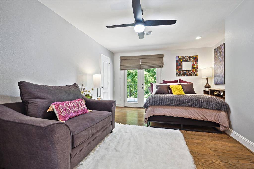Upstairs secondary bedroom with French doors leading to the balcony, large walk-in closet and en-suite bath