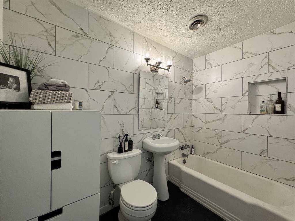 Bathroom with tile to ceilimg.