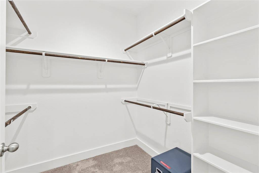 Walk in closet in the primary bathroom
