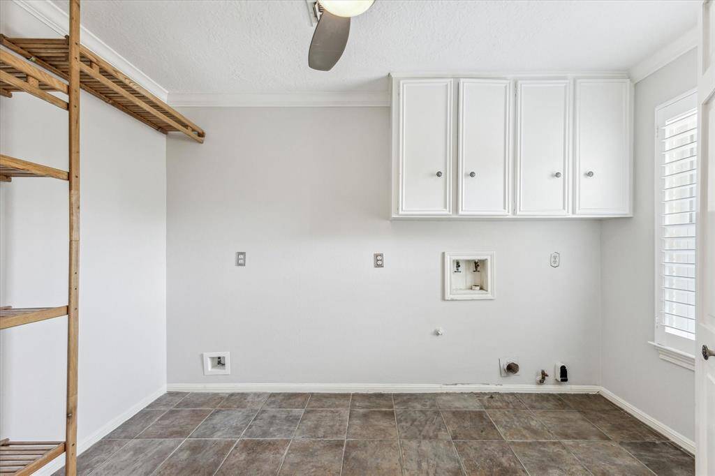 Large laundry room with storage.