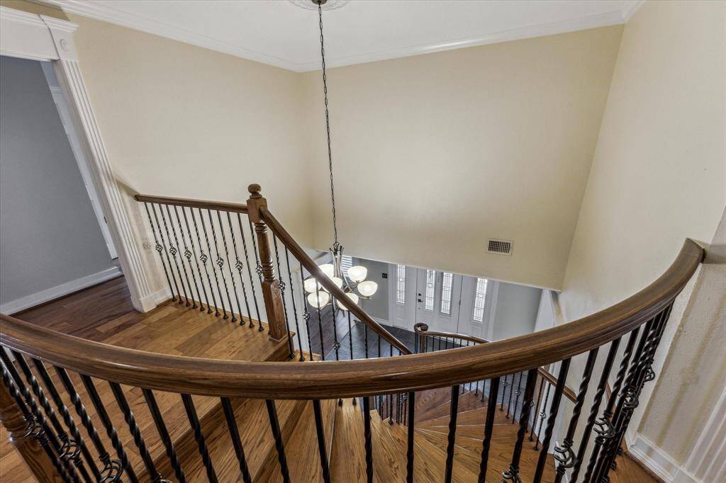 A view from the top of the stairs. The primary bedroom is the first room on the right.