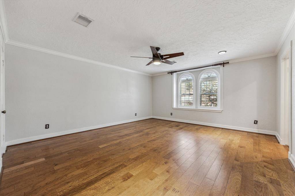 Expansive primary bedroom at the top of the stairs.