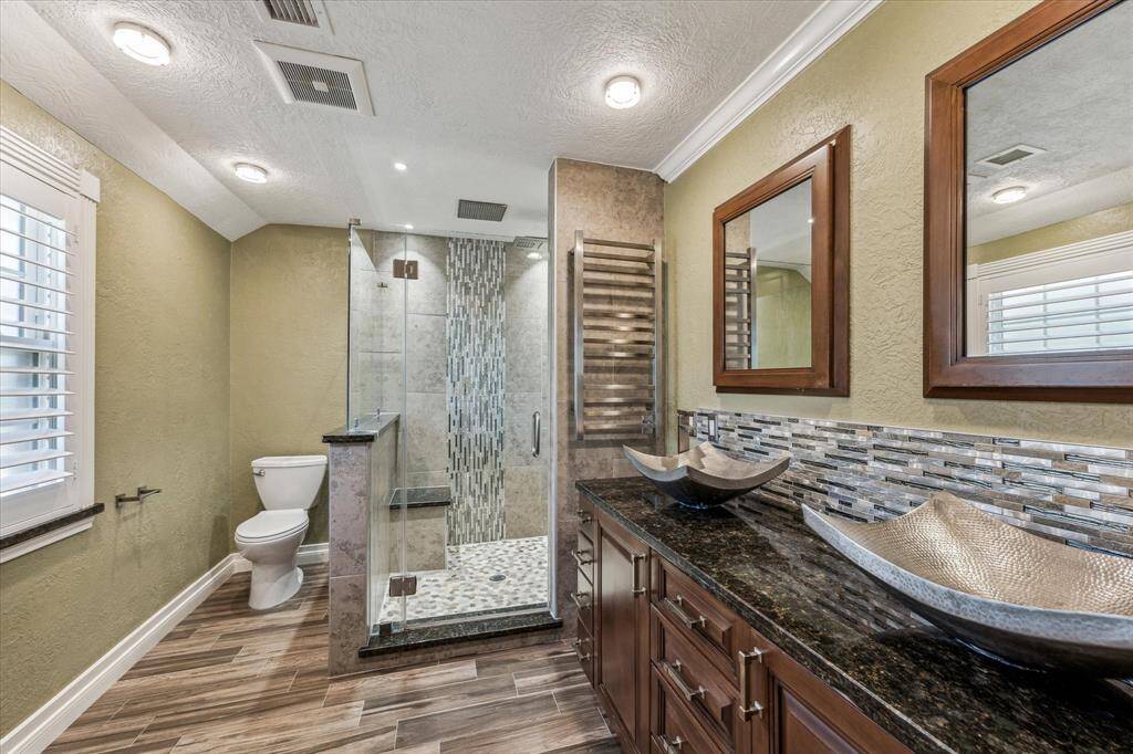 Another view of this gorgeous, updated primary bath with body sprayers and heated towel racks.