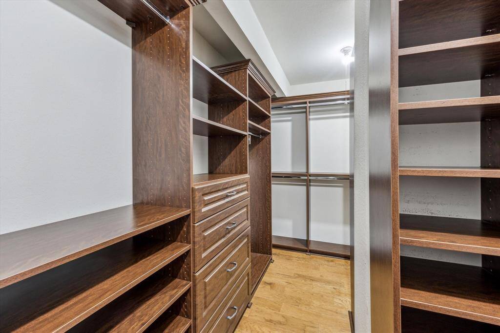 Huge walk in closet in the primary bedroom with custom built ins!