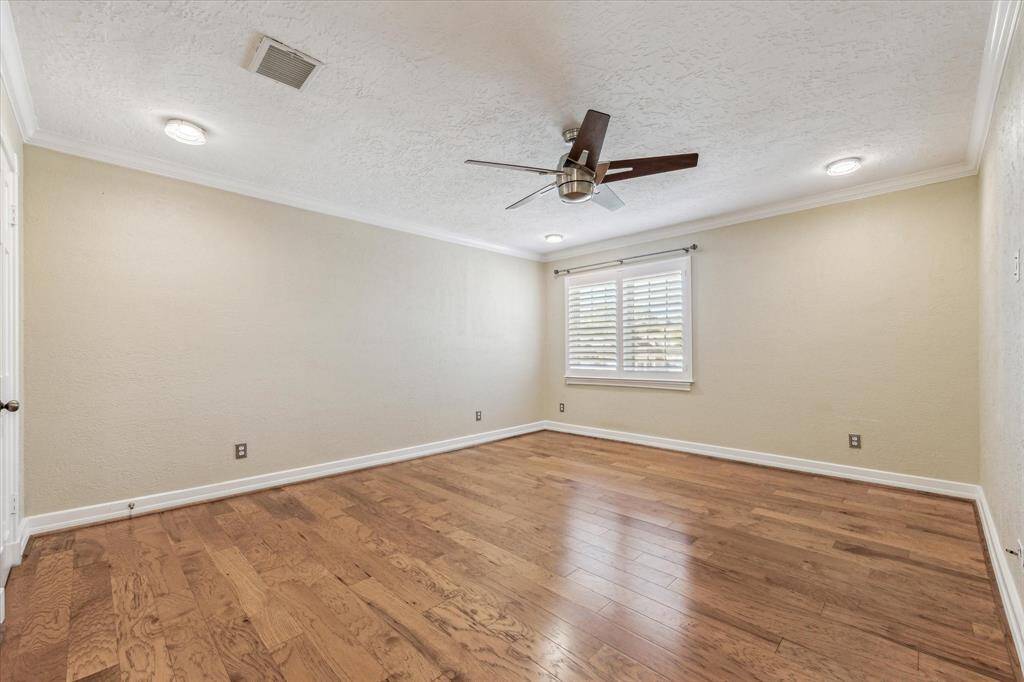 One of three large secondary bedrooms. All secondary bedrooms have walk-in closets with custom built ins.