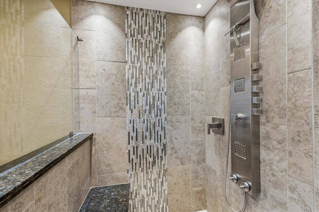 Both full bathrooms have beautiful finishes and body sprayers in the shower.