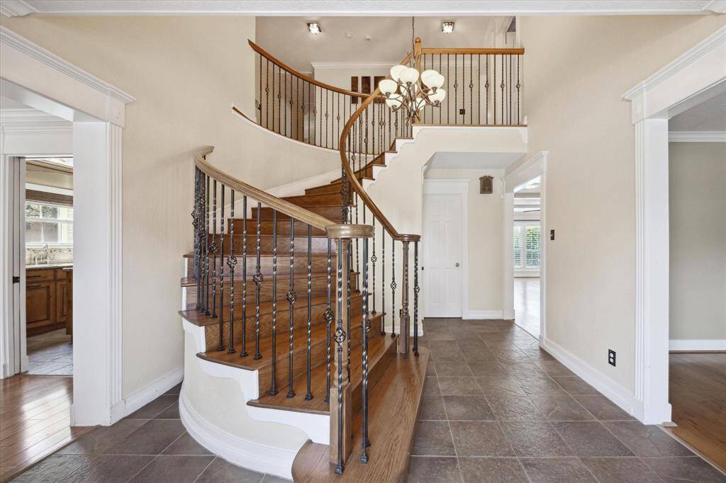 Enter to a grand, spiral staircase and vaulted ceilings!