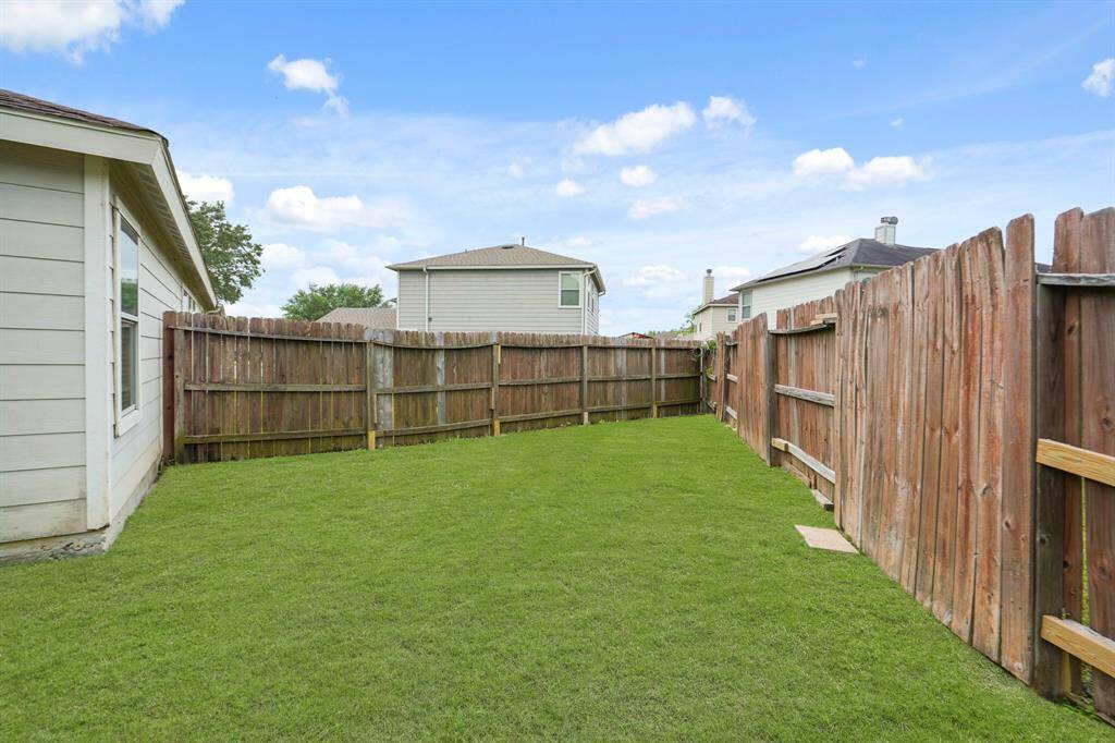 This backyard features solid board fencing providing more privacy.