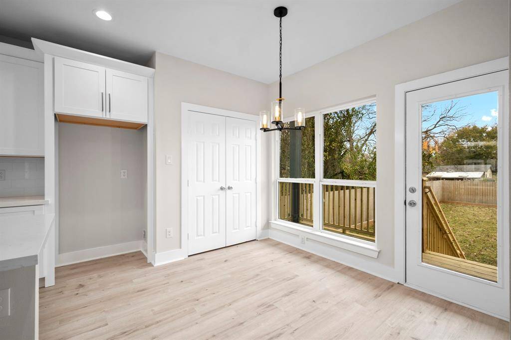 View from the dining area to the backyard and outside deck. Amazing natural light. It now comes with Samsung brand new refrigerator.