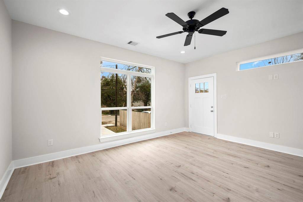 View from kitchen into living room. Large window with amazing natural light. 1st floor.