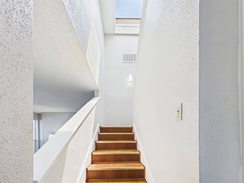 Stairway to the second floor is flooded with natural light thanks to the skylight