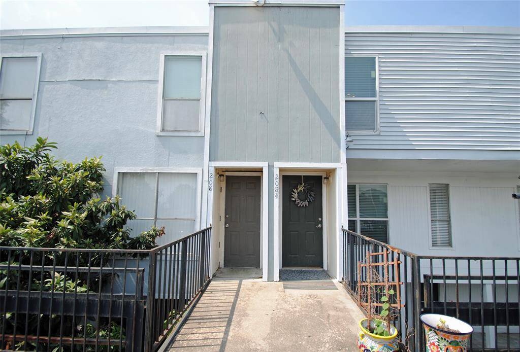Front door entry steps from 2 dedicated parking spots in Gated parking lot.