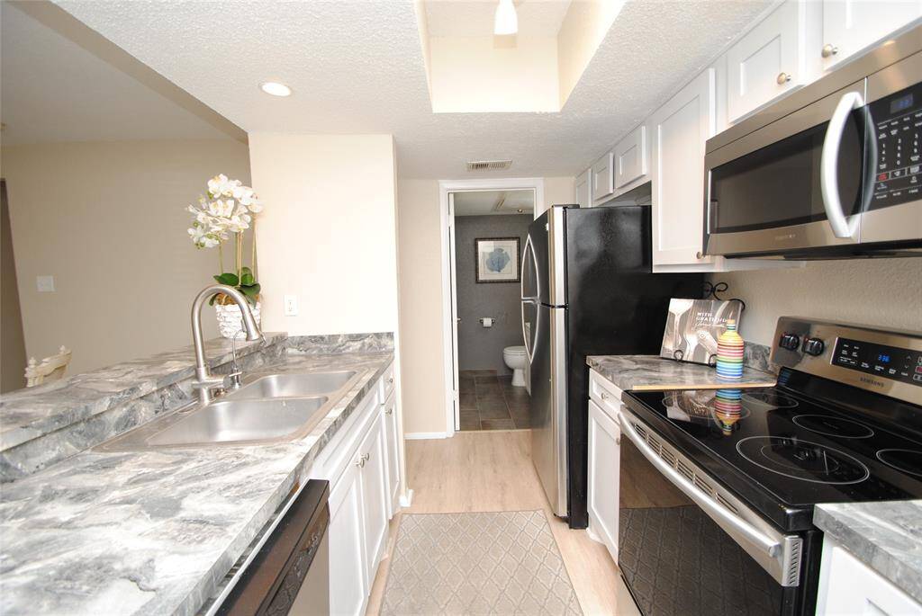Downstairs Half bath resides off the kitchen.