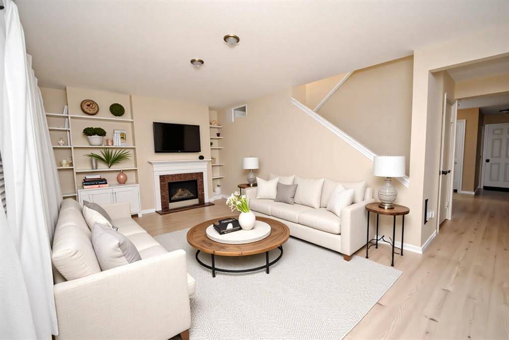 Roomy and open Downstairs Living Room with inviting fireplace.