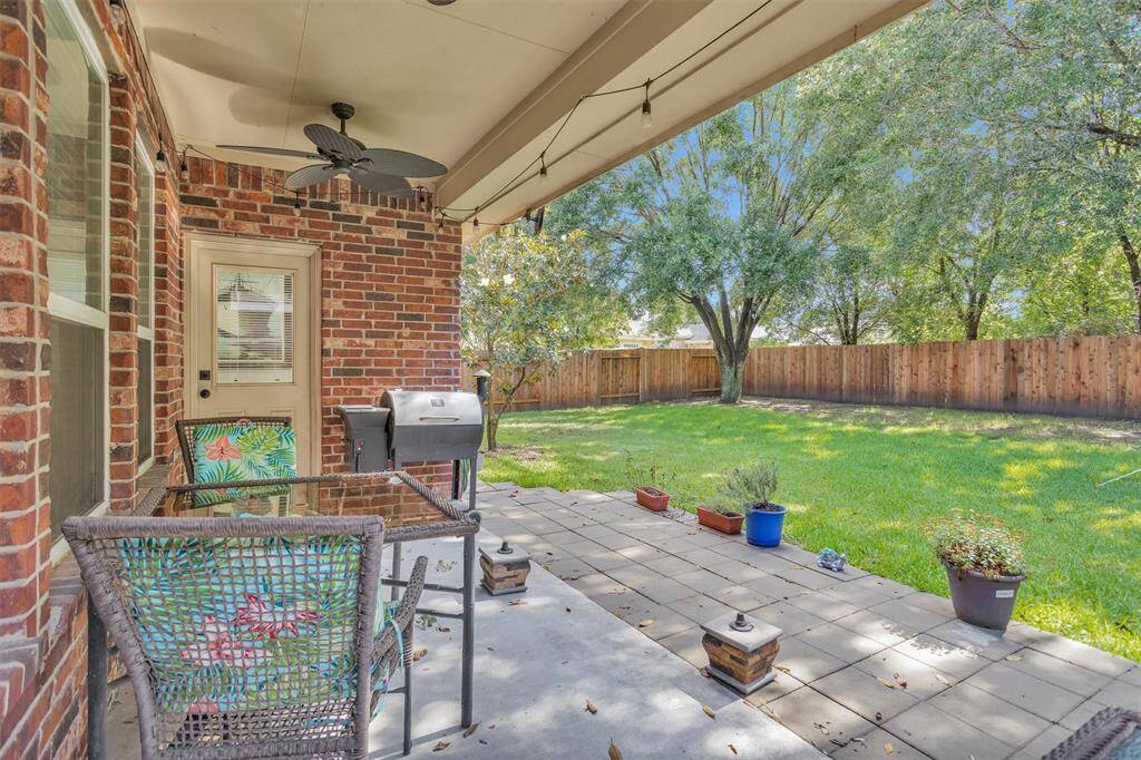 Covered porch with 2 ceiling fans and string lights.  Great area for grilling and enjoying family or friends!