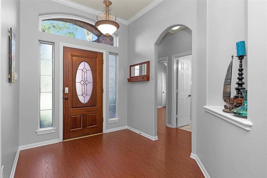 Arched doorways and wood floors create a modern and inviting look.