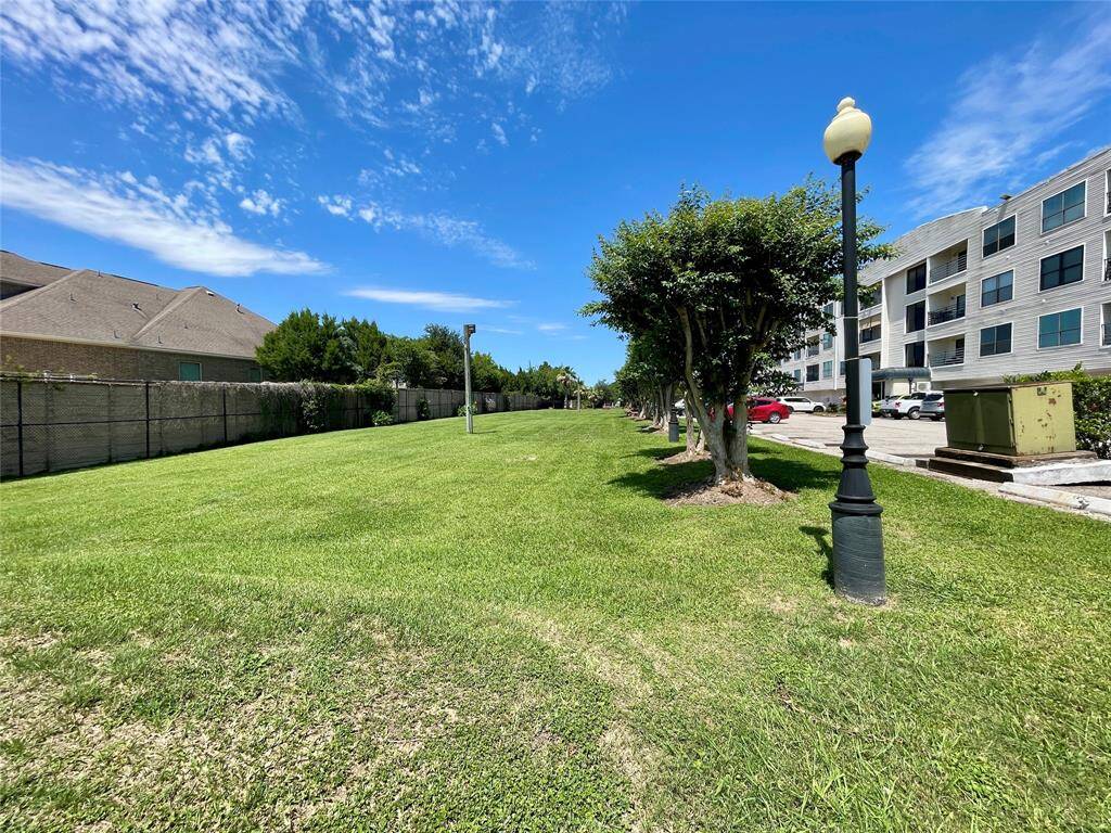 VIEW OF GREEN SPACE AND CONDO BUILDING
