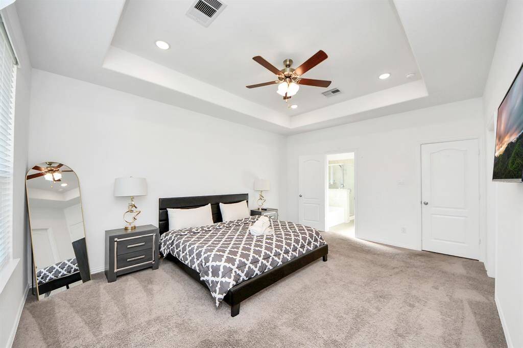 Large primary suite with bolted ceilings.