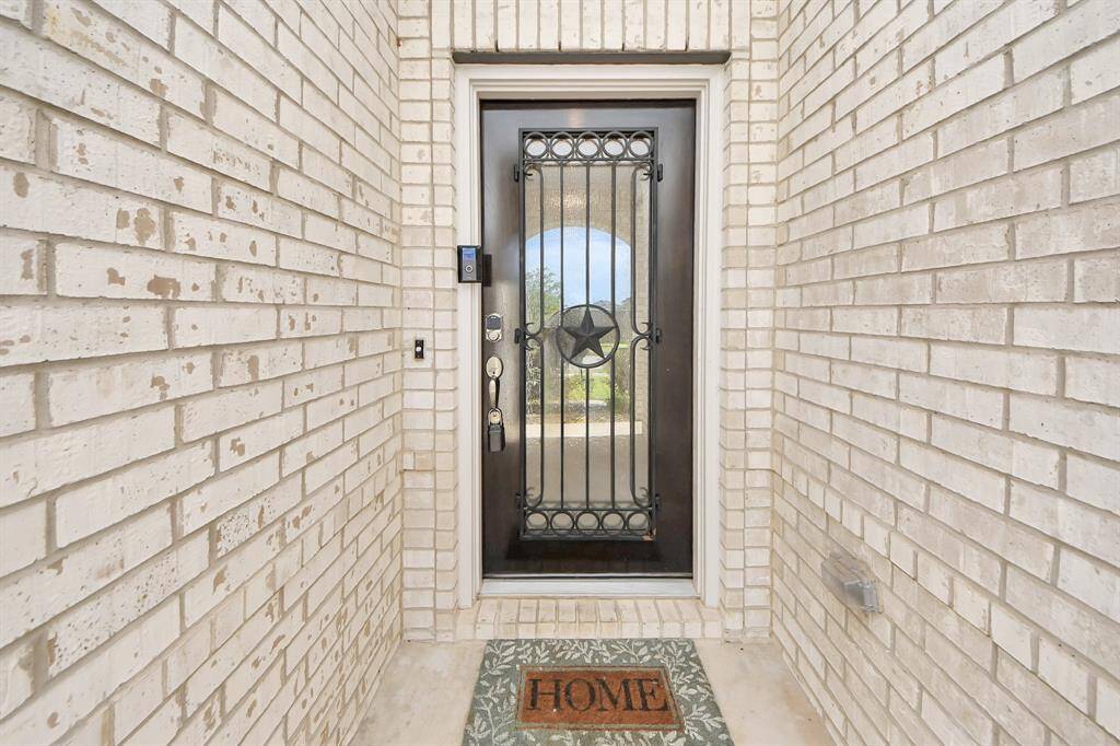 Front door entrance hallway with great looking glass front door.