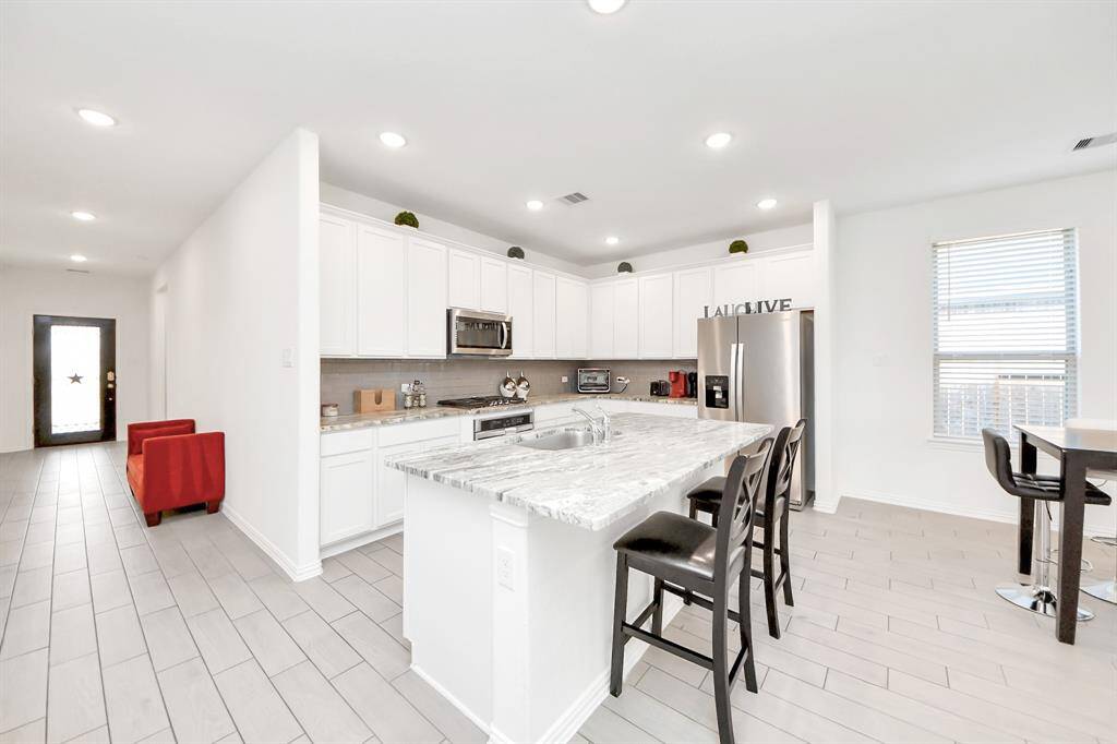 open concept Gourmet style kitchen with Stanley steel appliances and gas cooktop.