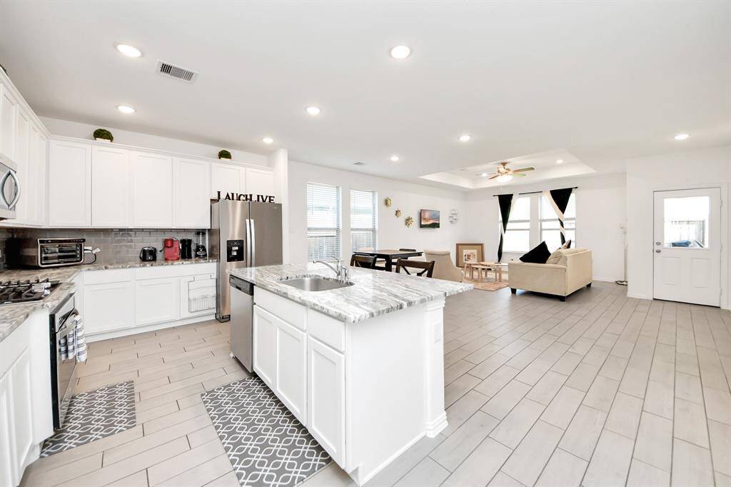 Gourmet style kitchen with Stanley steel appliances and gas cooktop.