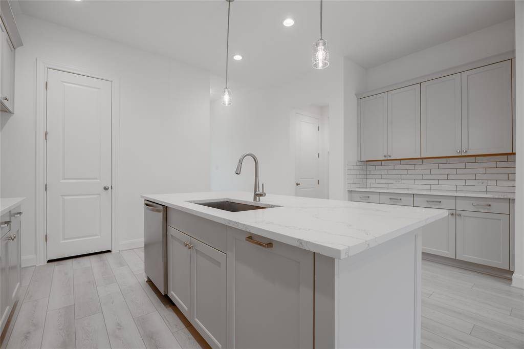 Kitchen with Pendant Lighting and Plenty of Cabinet Space
