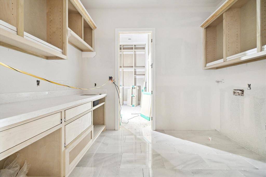 Laundry room with primary closet access.  Construction as of May 24.