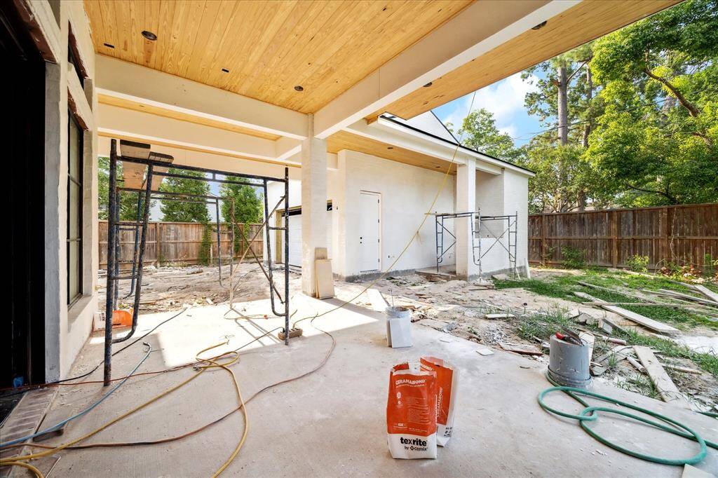 View toward the additional covered area, breezeway from the garage and the outdoor grill located on the side of the garage.  This will not disappoint.  Construction as of May 24.