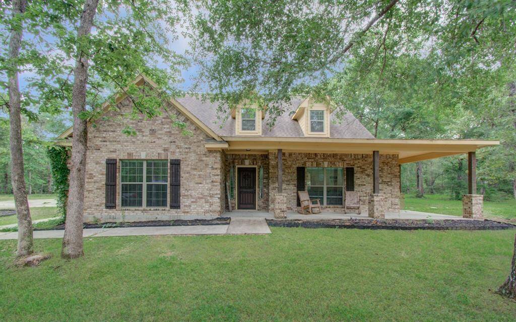 Front elevation of this spacious 4 to easily 5 bedroom home with quiet peaceful private living, with an upgraded  expanded covered porch.
