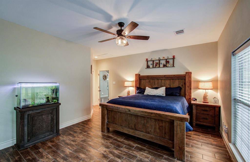 Primary bedroom upgraded with a ceiling fan w/ LED lighting.