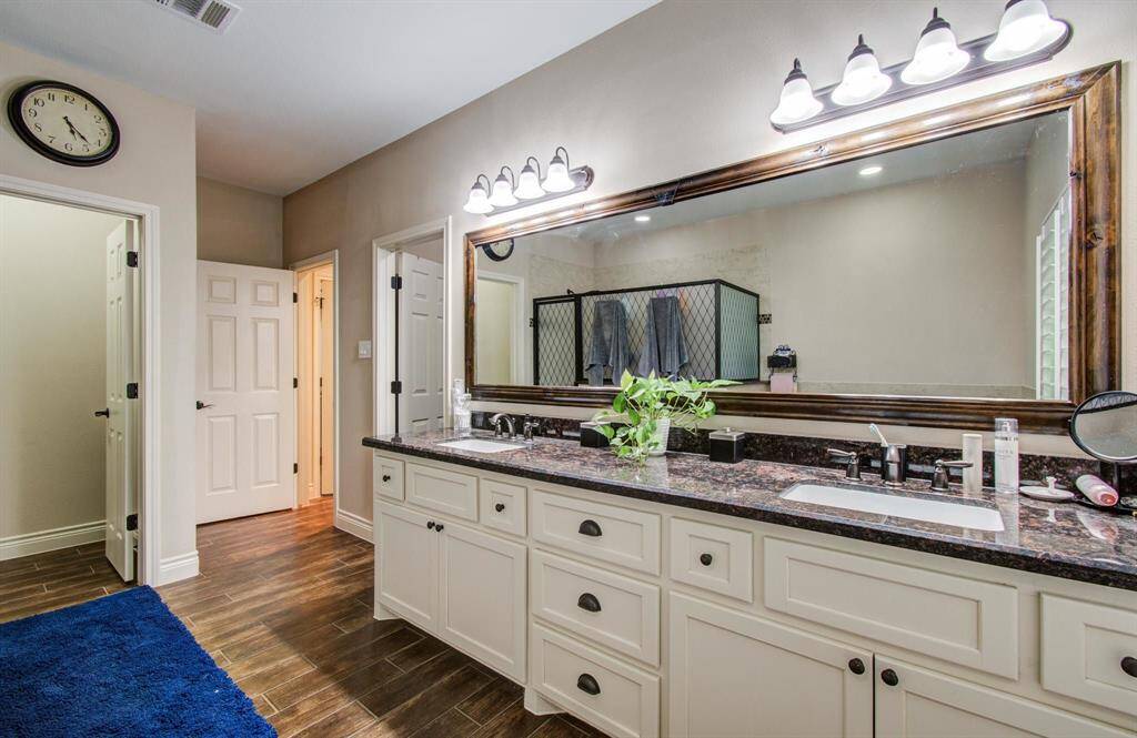 Spacious primary bath with dual vanities offering a good amount of storage from the additional drawers & cabinetry. The primary bath also includes an individual water closet with privacy door.