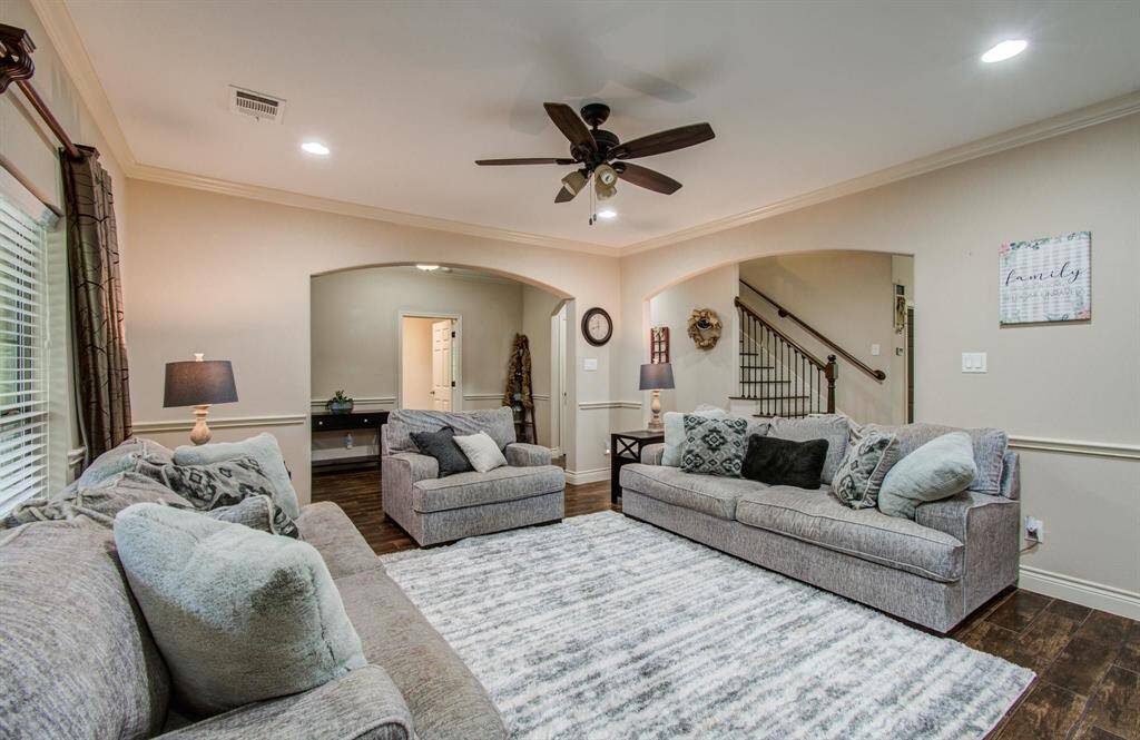 Spacious living room with LED recessed lighting.