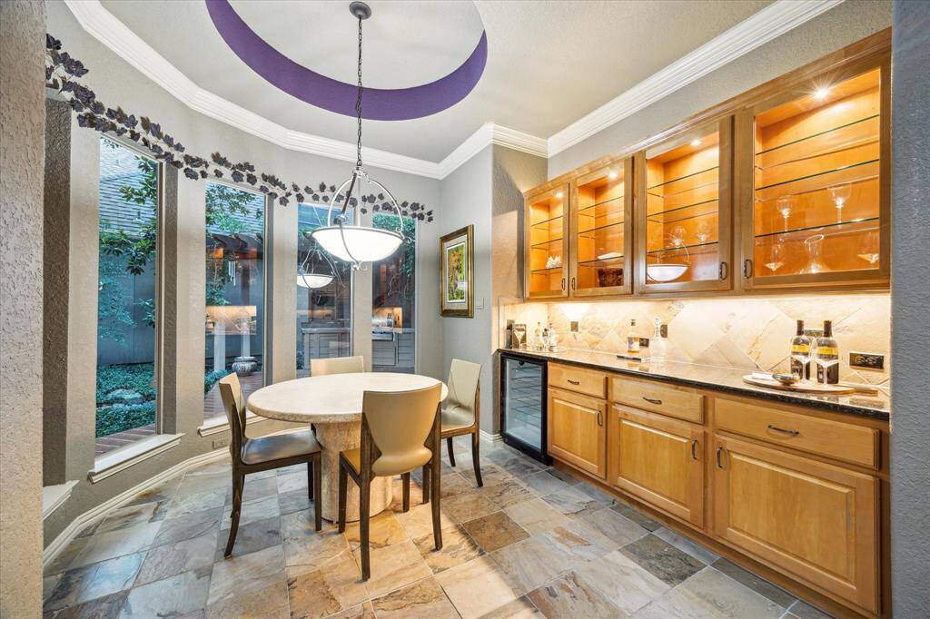 Breakfast nook, built in cabinets with lighting, bar, 1 of 2 wine refrigerators