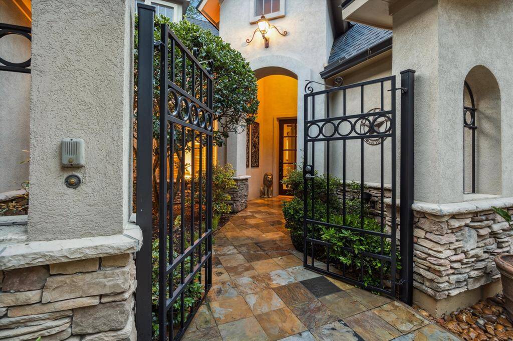Beautiful covered, gated entryway with intercom system.