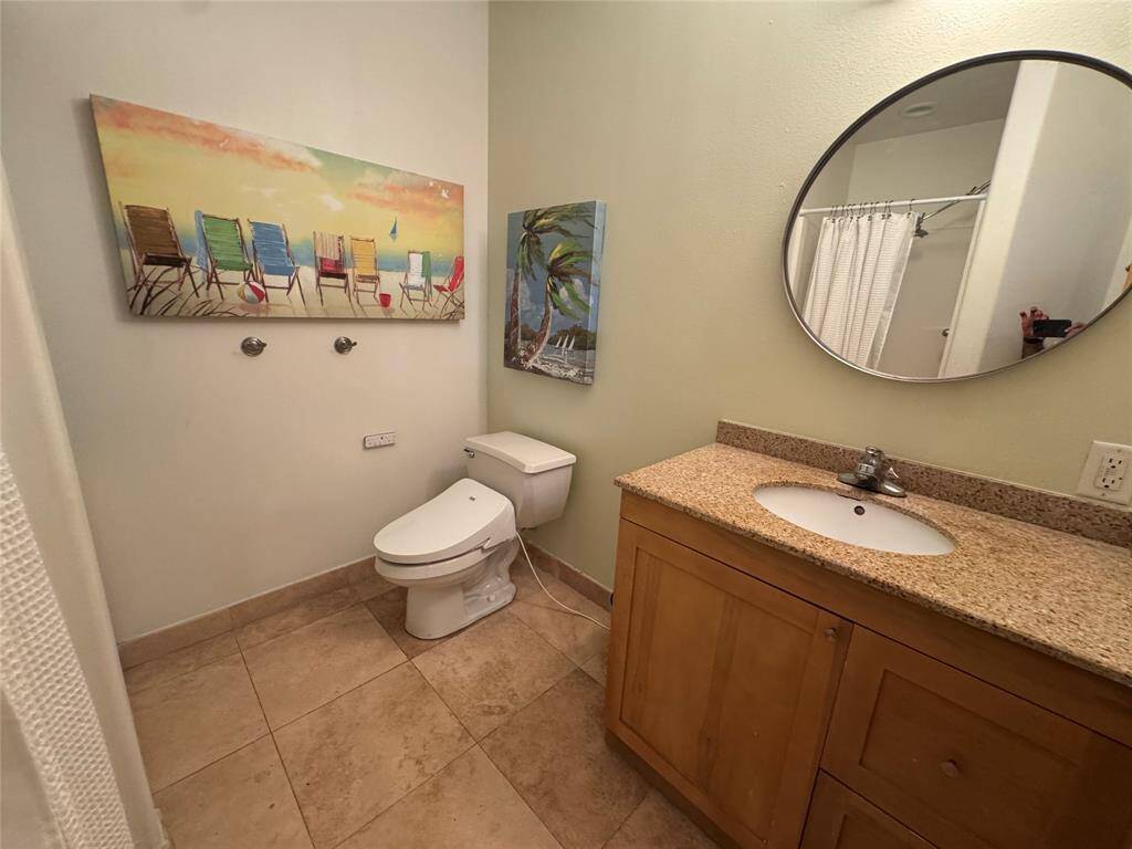 Spacious hall bath with full size washer/dryer and walk-in shower.