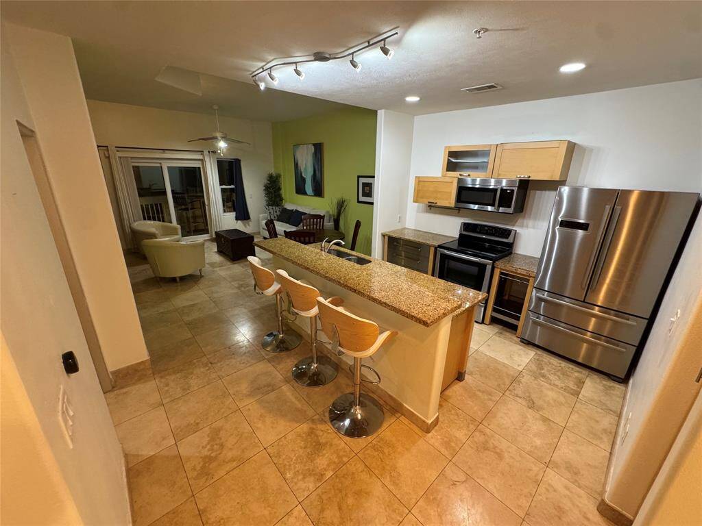 Open floor plan. Enjoy an informal meal or drinks at the bar. Or dine comfortably at the dining table. Unit is fully furnished.