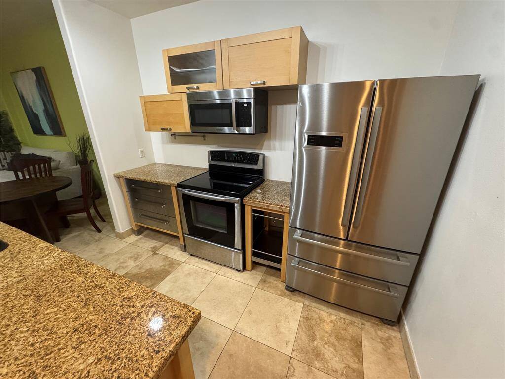 Kitchen includes recent Bosch refrigerator, microwave and dishwasher.