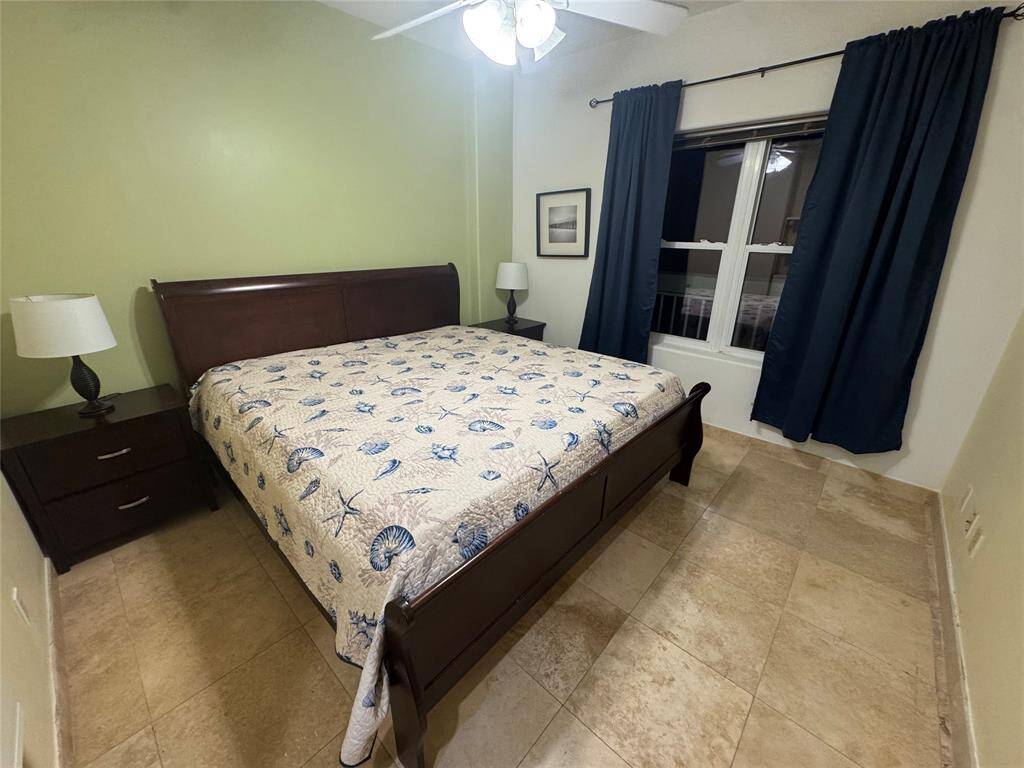 Primary bedroom and King-size bed with memory foam mattress . Black-out curtains let you sleep in on the weekends. Window looks out to the sea.
