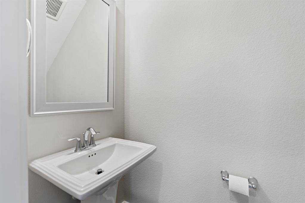 The powder room is conveniently situated on the first floor for easy access.