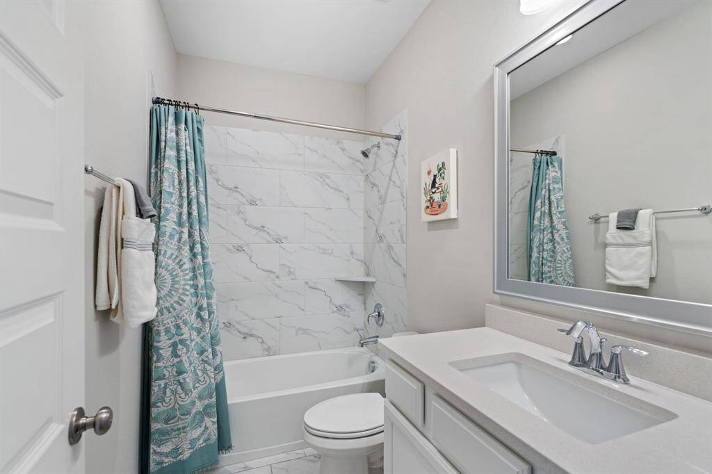 The two secondary bedrooms share a well-appointed hall bath.