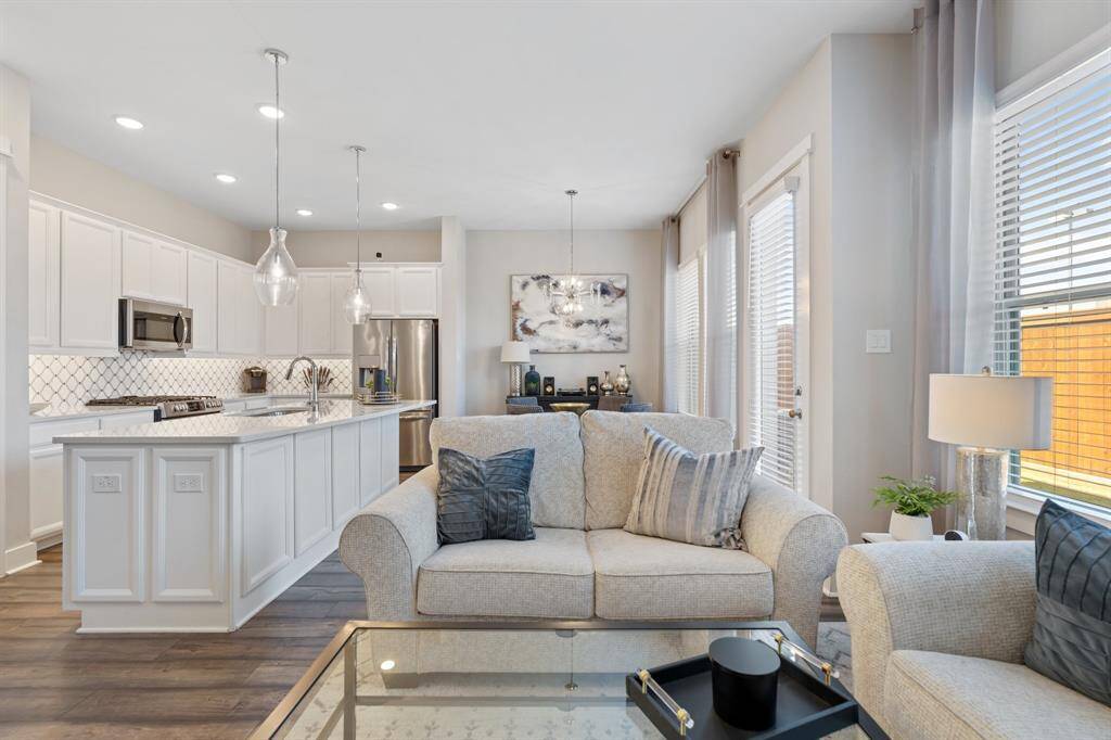 The open-concept living space flows seamlessly into the kitchen, creating an atmosphere great for entertaining.