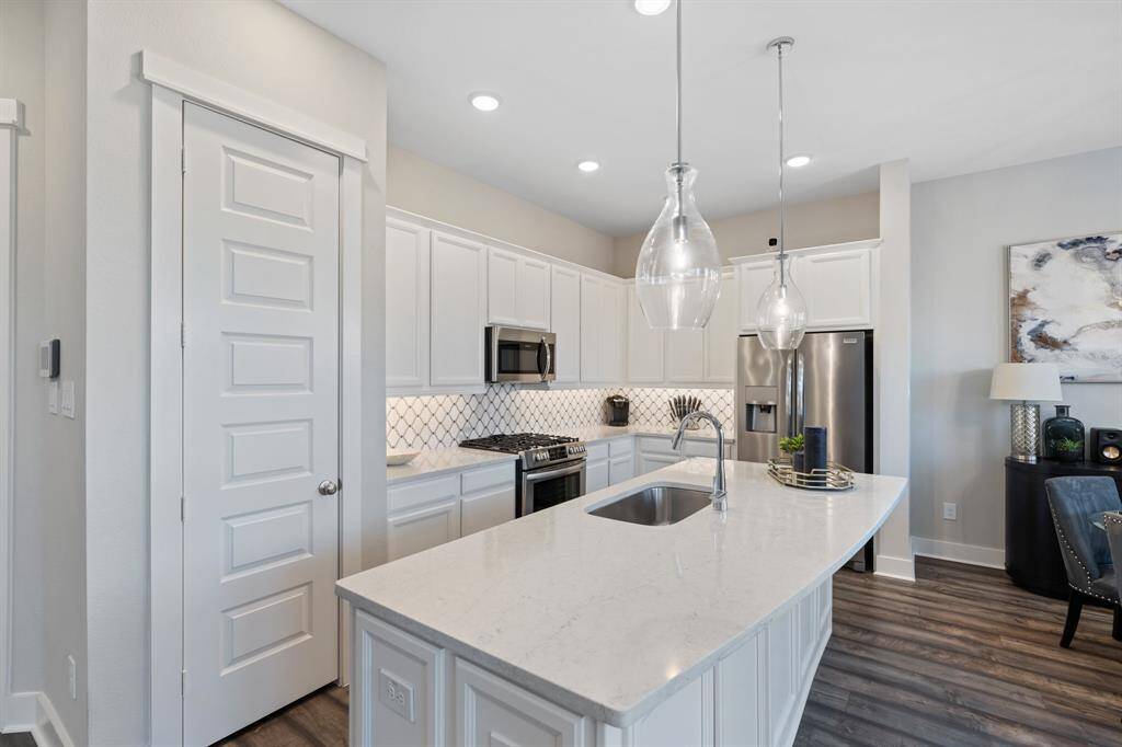 Sleek features and a spacious island ideal for gathering and entertaining.