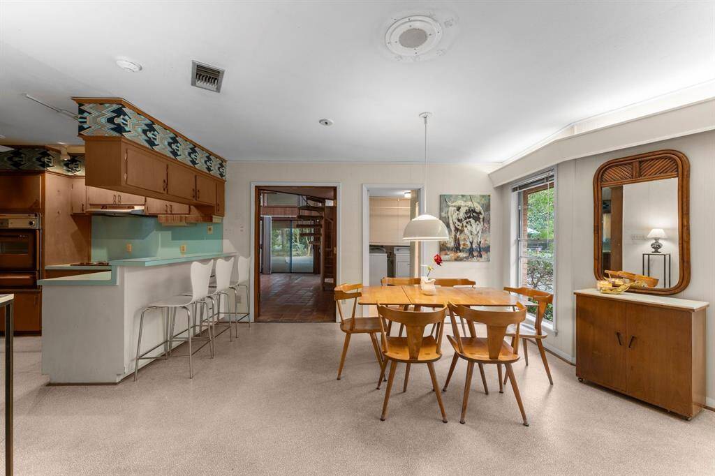 View of kitchen space leading to den.