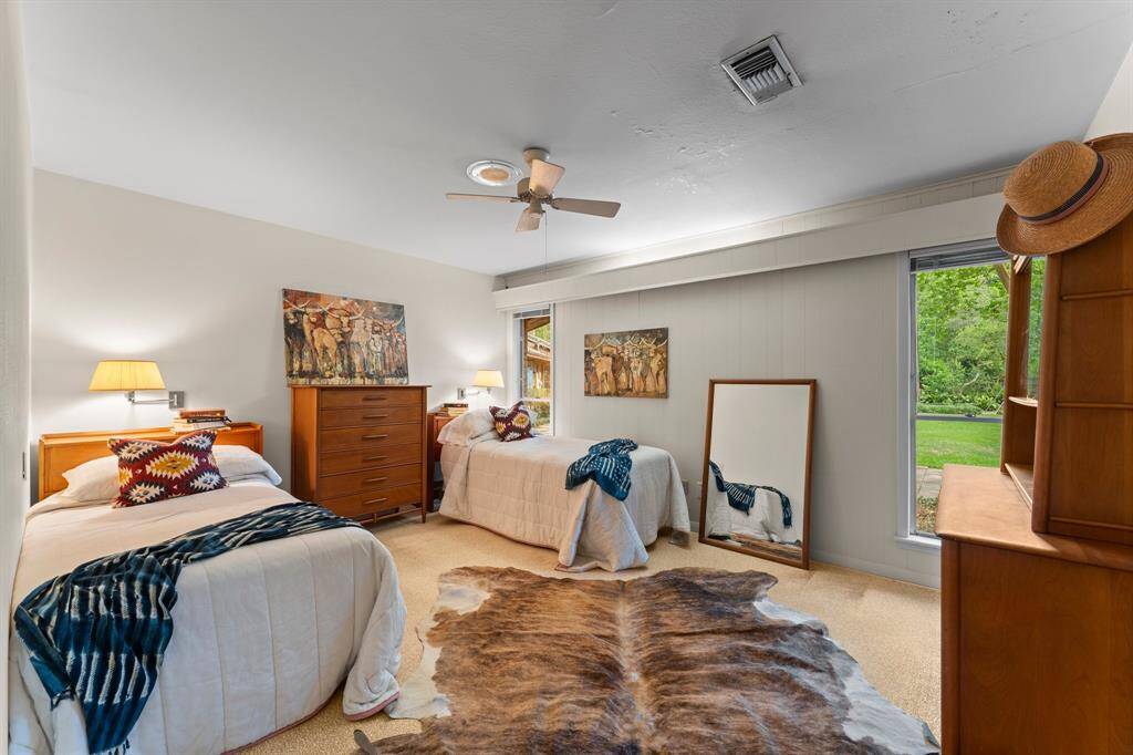 Bedroom 3 can easily accommodate a king sized bed between windows with views of backyard.